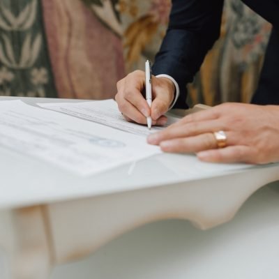 Man with a pen signs a document